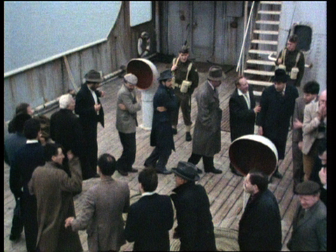 Photo copyright: Weis Films. Men walking on deck.