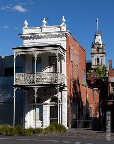 two-storey narrow building with balcony